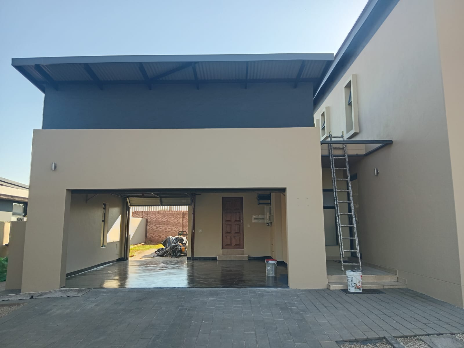 Repainted double-storey home exterior with charcoal and beige finish