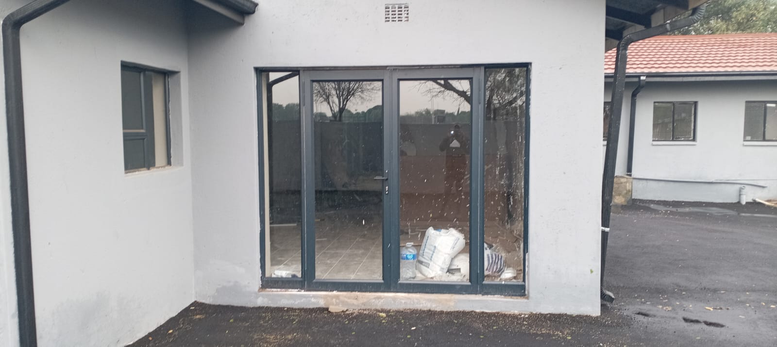 Charcoal aluminium patio doors fitted to a residential outbuilding